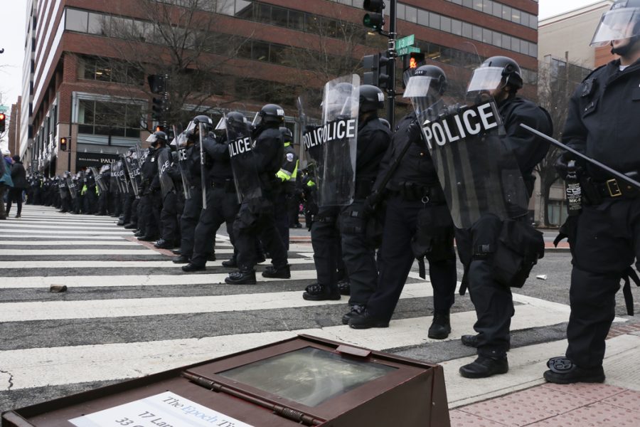 A scuffle between protesters and police brings down a mailbox at K and 13th streets NW. Elaina Zachos | Senior Staff Photographer