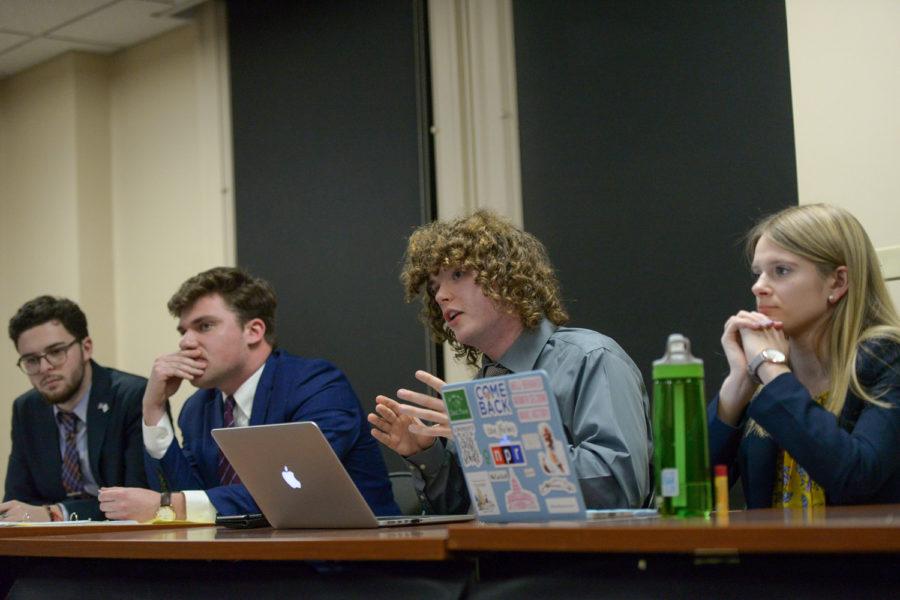 Pitt College Republicans' Corey Barsky (far left) and Phil Saggese (center left) listen as Pitt College Democrats' Mackenzie Coat (center right) and Maureen Hartwell (far right) speak during Monday evening’s health-care debate.