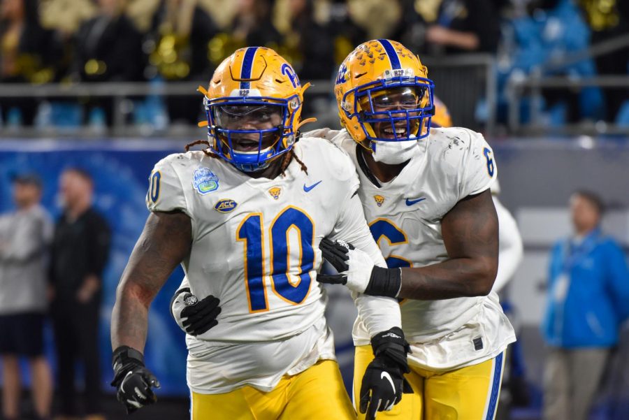 Keyshon Camp (10) and John Morgan III (6) embrace after a defensive play during the ACC Championship football game. 