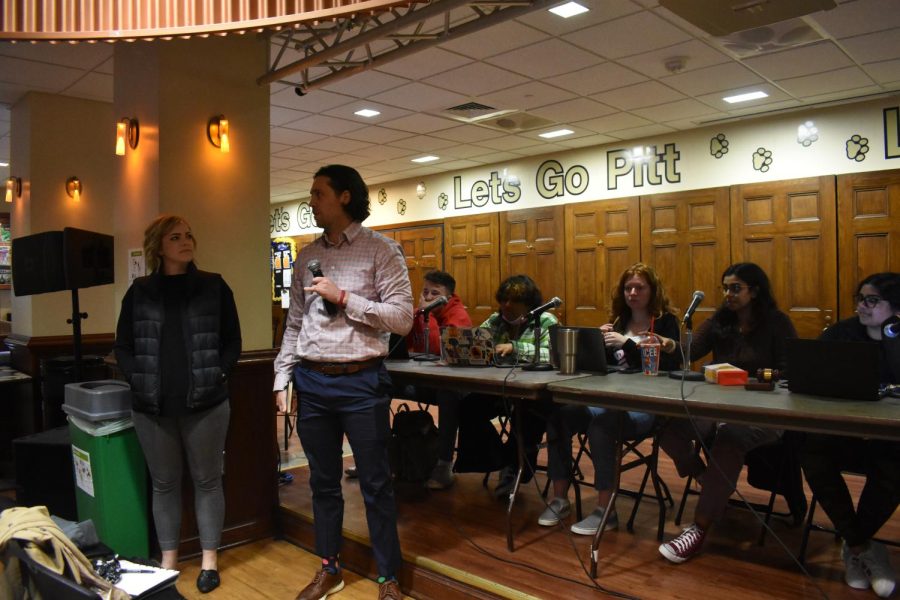 Kathryn Lavelle (left) and Steve Schurr, representatives from Pitt Eats, speak at Student Government Board’s weekly meeting in Nordy's Place on Tuesday night.
