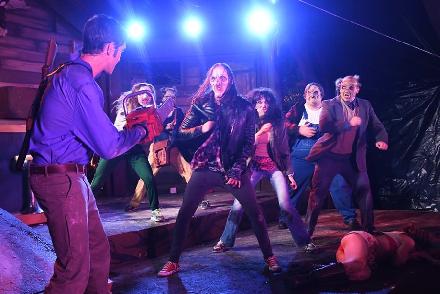 The cast of Evil Dead: The Musical perform on stage.
