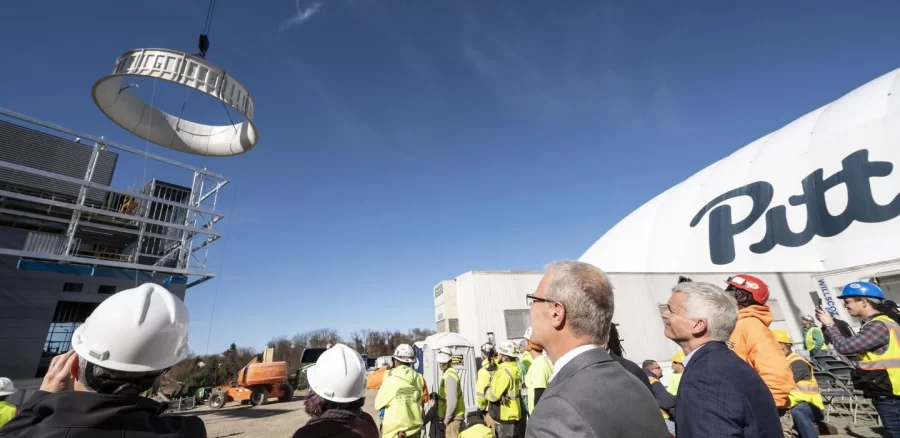 A crowd watches as the final section of the cooling tower for Pitt’s new chilled water plant was lifted into place on Nov. 8.