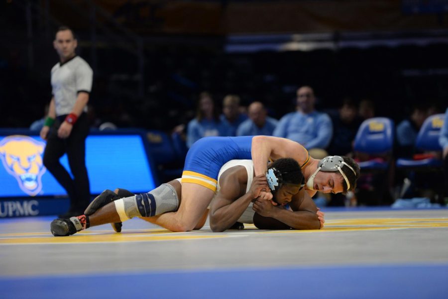 No. 29 Tyler Badgett wrestles his Iowa State opponent on Friday night. 