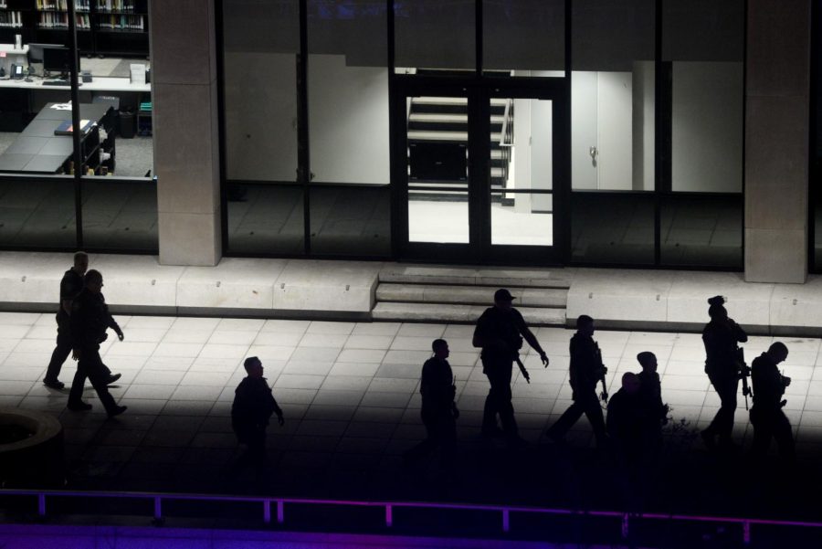 Police exit Hillman Library Monday night after evacuating students from the building.