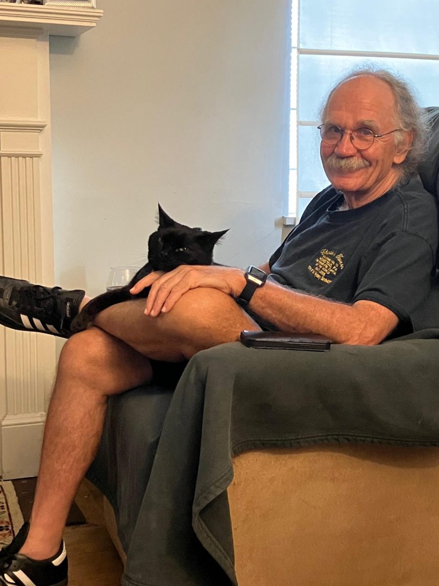 Tony Novosel smiles for a photo with one of his cats. 