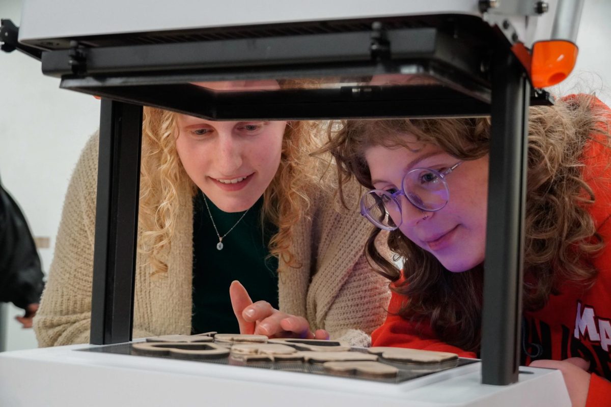 Emily Staerk (left) from Spring-Ford High School and Ryleigh Marks (right) from Moon Township prepare vacuum forming molds during the Pink Panther event on Friday evening.