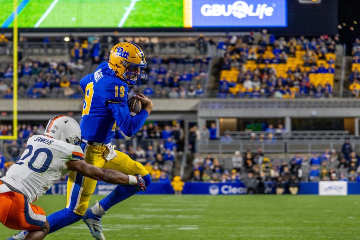 Redshirt junior quarterback Nate Yarnell (19) runs with the ball at the Pitt football game against Virginia in Acrisure Stadium on Saturday, Nov. 9.
