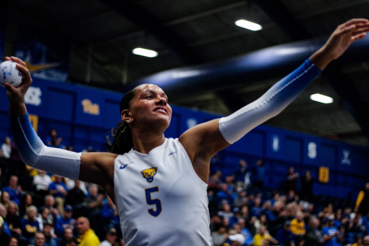Sophomore right-side hitter Olivia Babcock (5) prepares to throw a ball for spectators to catch during the Pitt volleyball game against FSU in the Fitzgerald Field House on Friday, Nov. 15.
