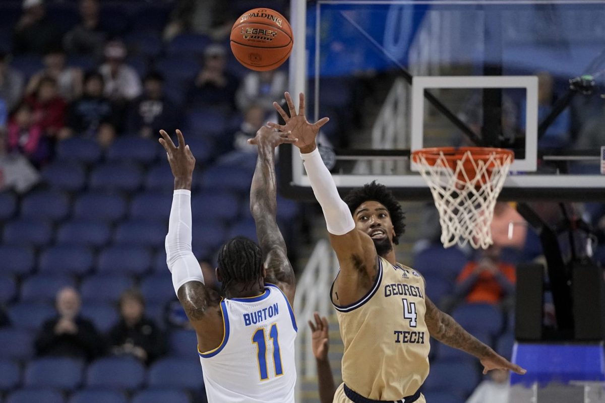 Pittsburgh guard Jamarius Burton shoots over Georgia Tech forward Javon Franklin during the first half of an NCAA college basketball game at the ACC Tournament, Wednesday, March 8, 2023, in Greensboro, N.C.