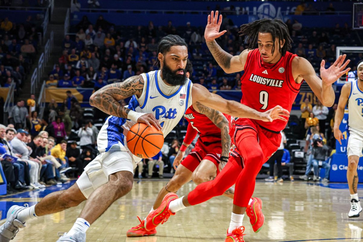 Graduate student guard Damian Dunn (1) maneuvers the ball down the court during the men’s basketball game against Louisville in the Petersen Events Center on Saturday, Jan. 11.