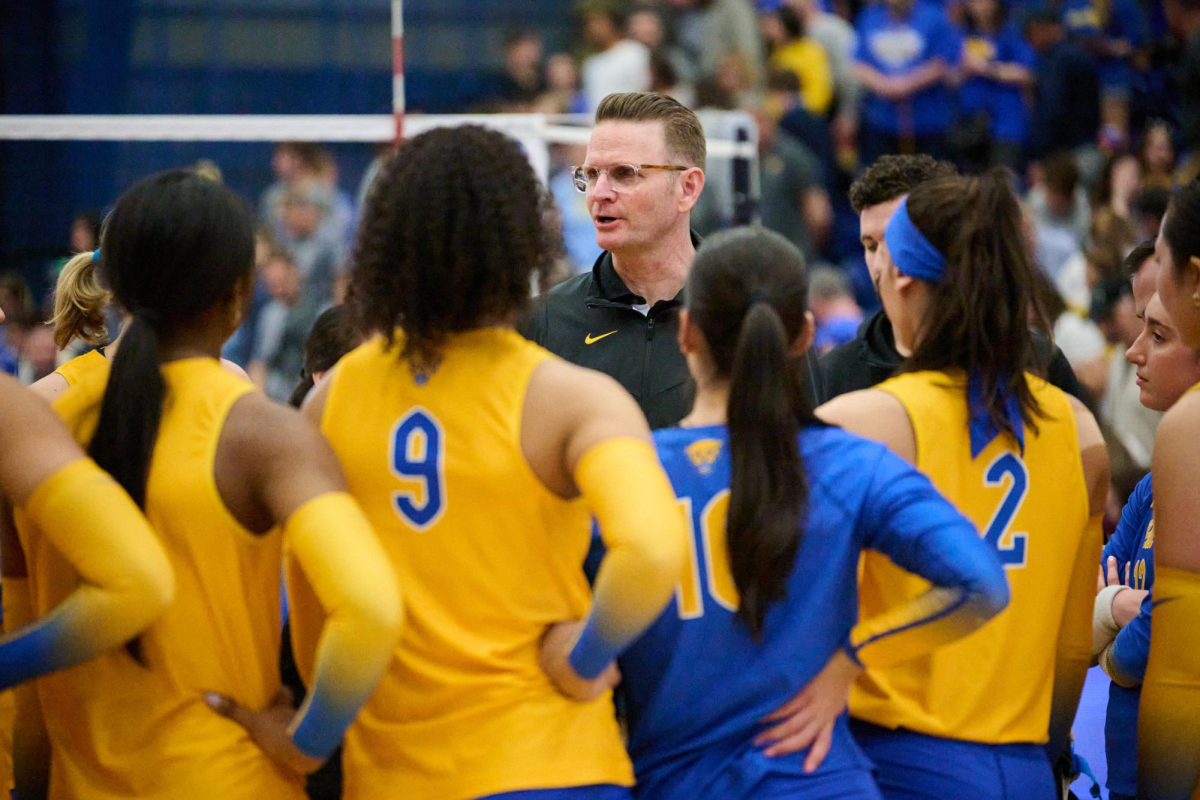 Head coach Dan Fisher speaks to the Pitt volleyball team after their match Fitzgerald Field House.