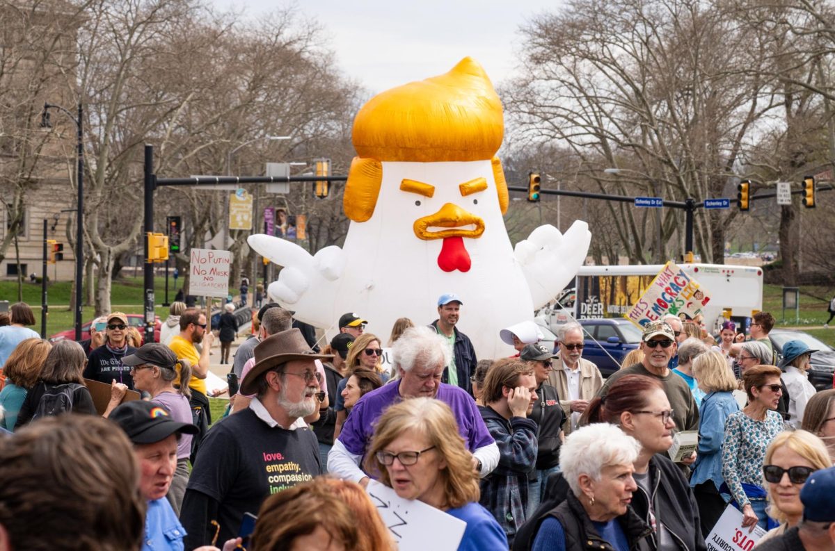 An inflatable “Trump chicken” floats above the crowd in Schenley Plaza on Saturday, March 29.
