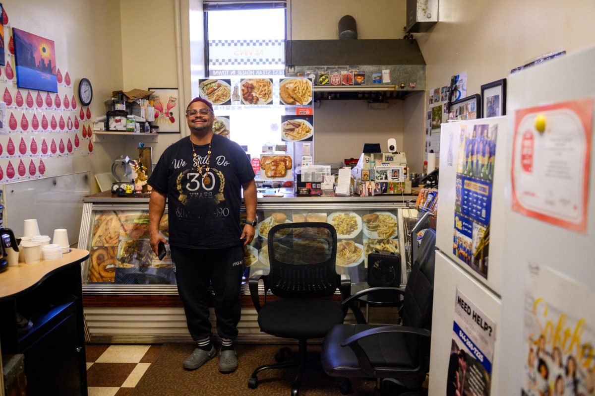Kevin McAllister poses for a portrait in his deli.